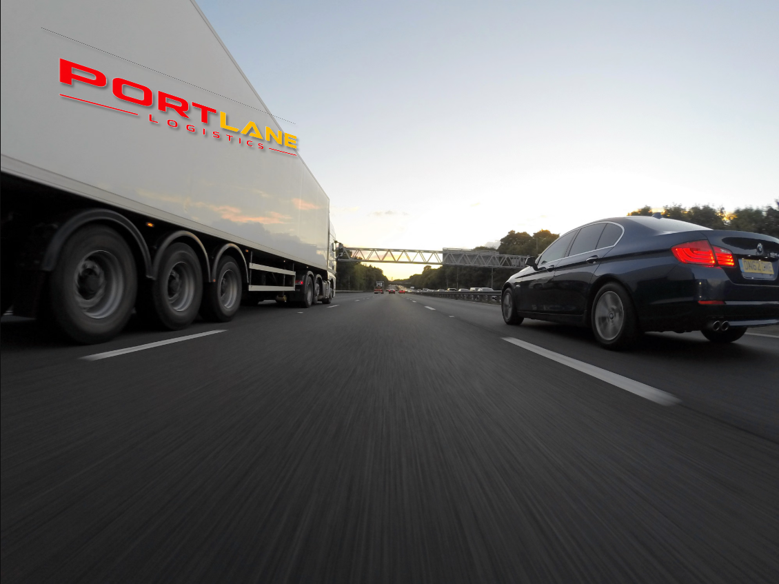 Portlane Logistics branded white European haulage truck on the motorway